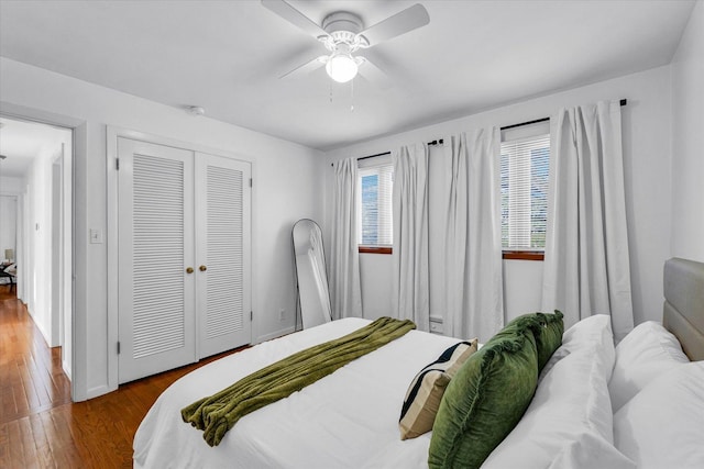 bedroom with ceiling fan, a closet, and hardwood / wood-style flooring