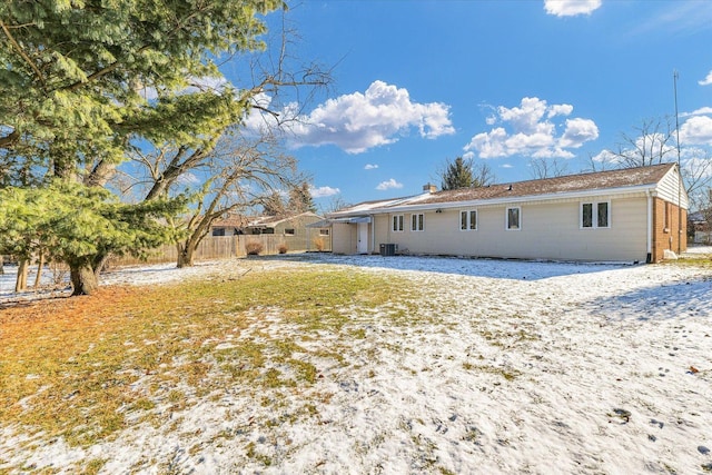 snow covered house with cooling unit