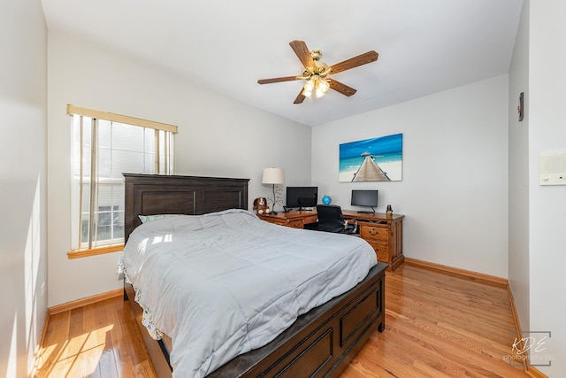 bedroom with light wood-style floors, ceiling fan, and baseboards