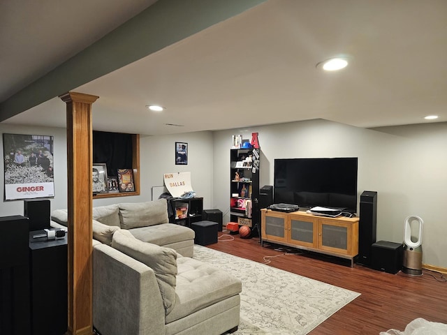 living area featuring decorative columns, wood finished floors, and recessed lighting