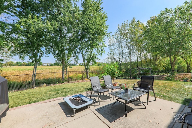 view of patio featuring an outdoor fire pit and a fenced backyard