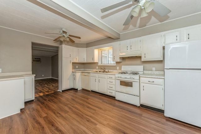 kitchen with white appliances, dark wood-type flooring, sink, beamed ceiling, and white cabinetry