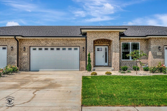 view of front of house featuring a front yard and a garage