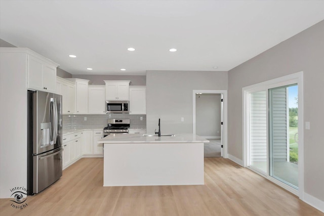 kitchen with white cabinetry, sink, an island with sink, and appliances with stainless steel finishes