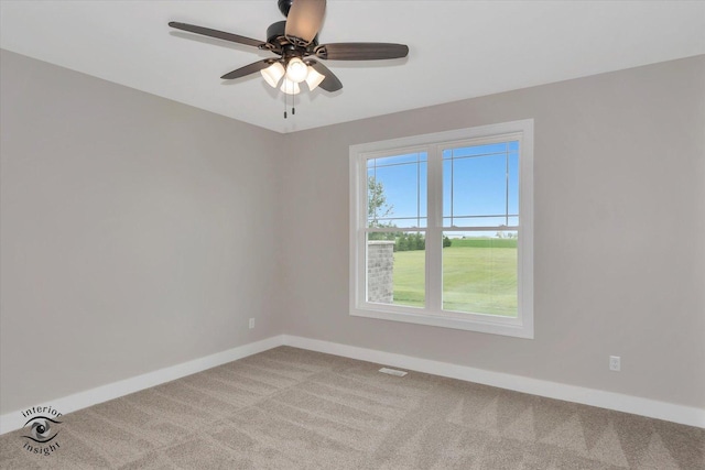 empty room with ceiling fan, plenty of natural light, and light colored carpet