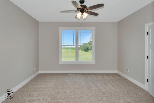 carpeted spare room featuring ceiling fan