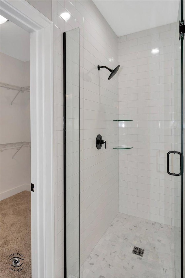 bathroom featuring a shower with door