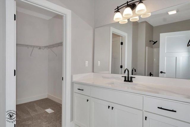 bathroom featuring vanity and a shower