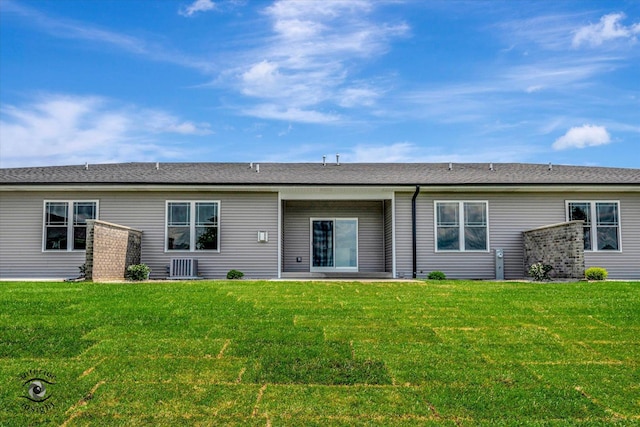 back of house with a lawn