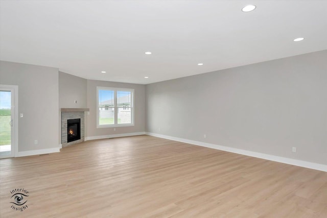 unfurnished living room with light hardwood / wood-style flooring