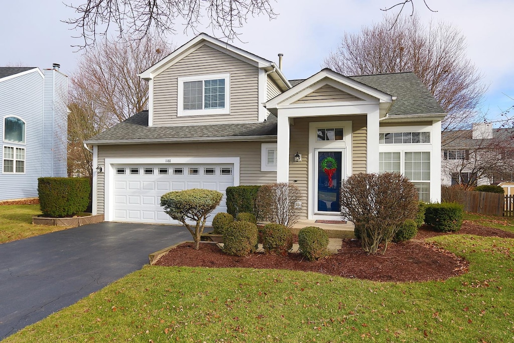 view of front of house with a garage and a front yard