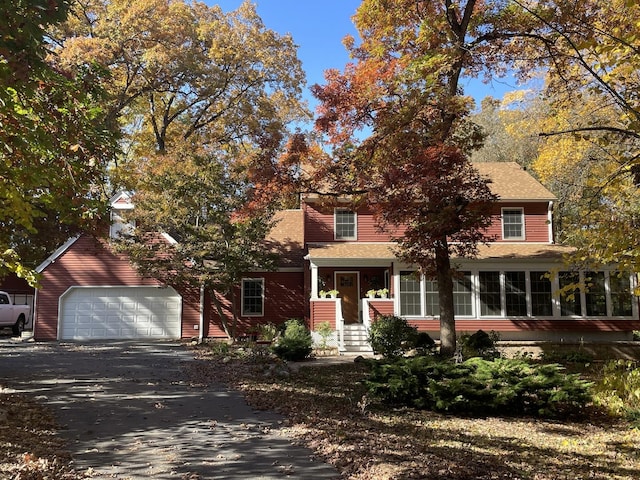 view of front of property featuring a garage and a sunroom