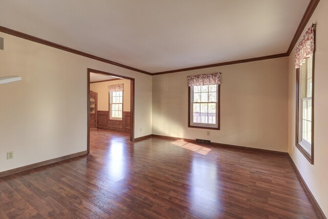 empty room featuring dark hardwood / wood-style floors and crown molding