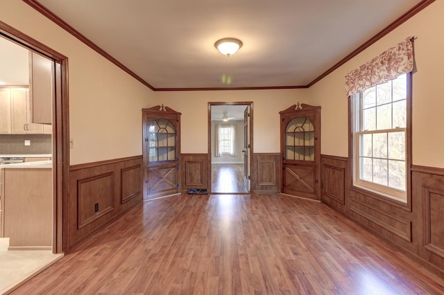 interior space featuring ornamental molding and light wood-type flooring