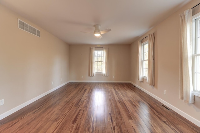 spare room featuring hardwood / wood-style floors and ceiling fan