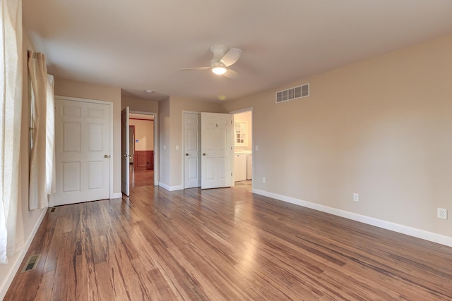 unfurnished bedroom with ceiling fan and wood-type flooring