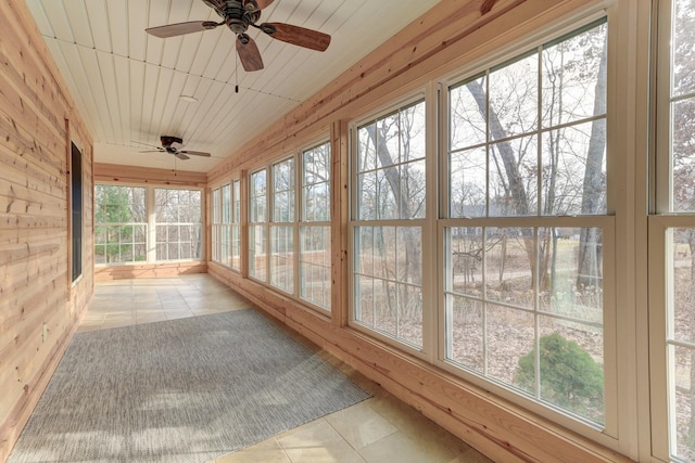 unfurnished sunroom featuring ceiling fan