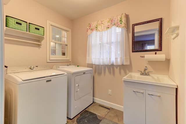 washroom featuring washer and clothes dryer, cabinets, and sink