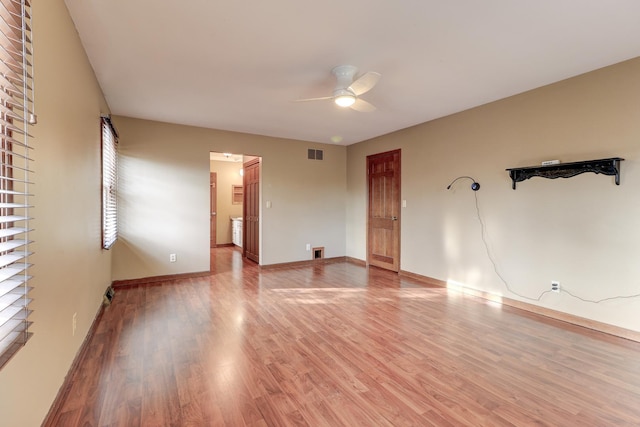 spare room with ceiling fan and hardwood / wood-style floors