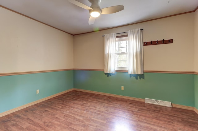 spare room with ceiling fan, wood-type flooring, and ornamental molding