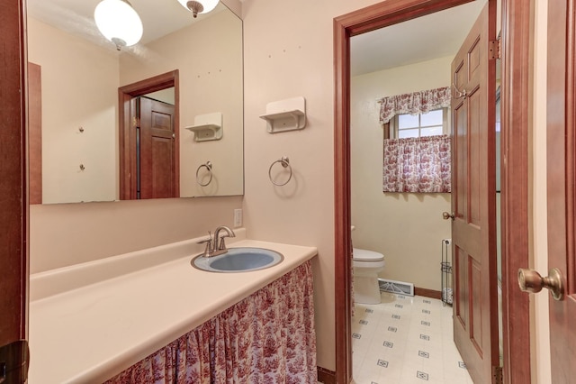 bathroom featuring vanity and toilet