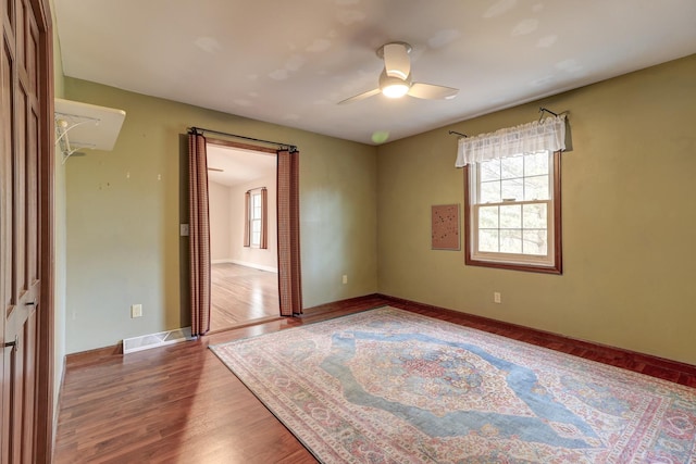 spare room with ceiling fan and wood-type flooring