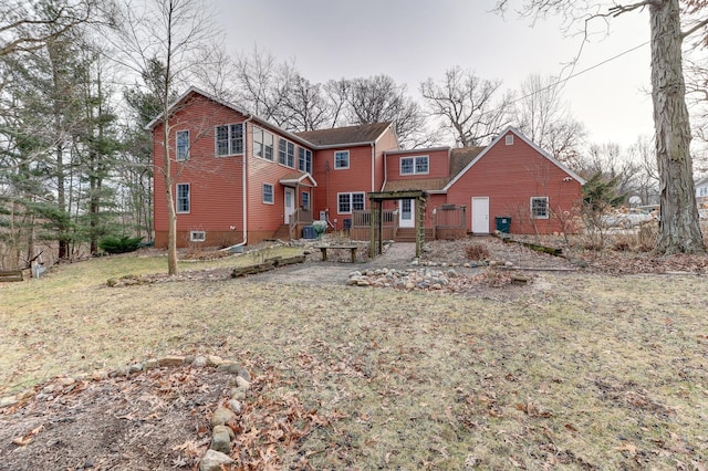 rear view of property with a lawn and central air condition unit