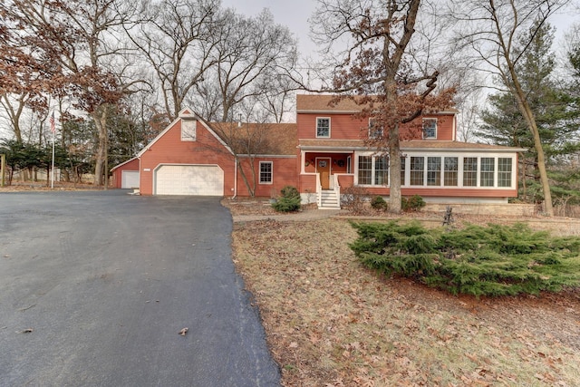 view of front of property featuring a garage and an outbuilding