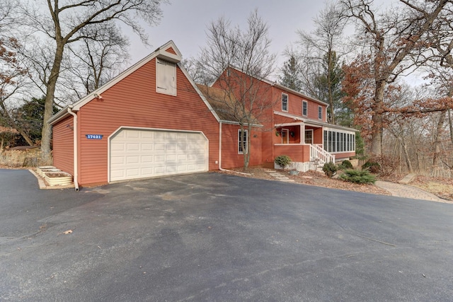 view of front property featuring covered porch and a garage