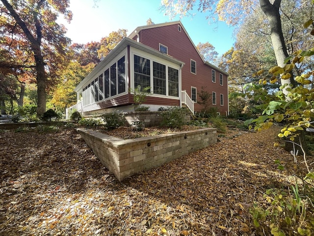 rear view of property with a sunroom