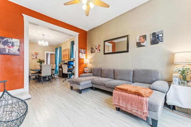 living room with wood-type flooring and ceiling fan with notable chandelier