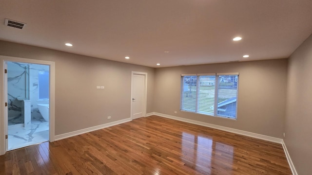 spare room featuring wood-type flooring