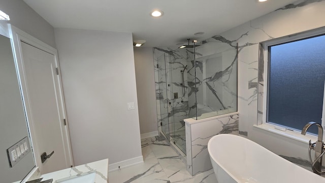 bathroom with vanity and separate shower and tub