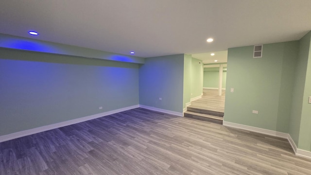 basement with hardwood / wood-style flooring