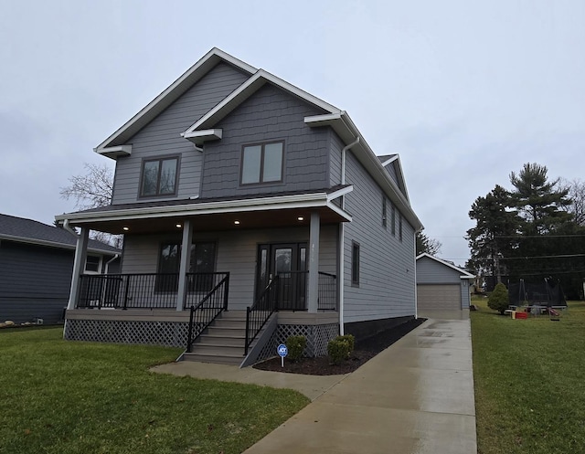 view of front of house featuring an outbuilding, a front lawn, a porch, and a garage