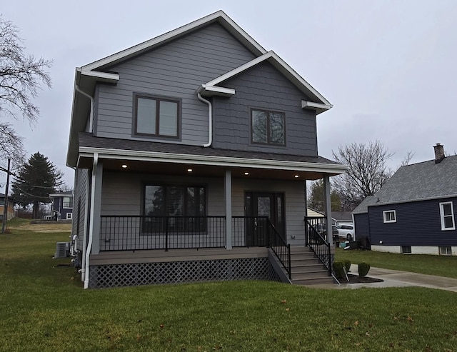 view of front of house featuring covered porch, a front yard, and central AC