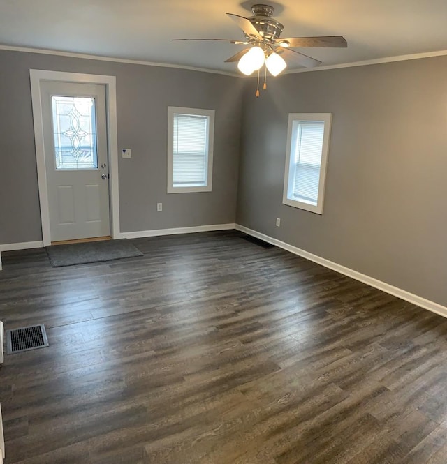 entrance foyer featuring dark hardwood / wood-style floors, ceiling fan, and crown molding