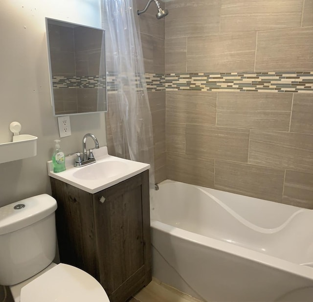 full bathroom with shower / bathtub combination with curtain, vanity, and toilet