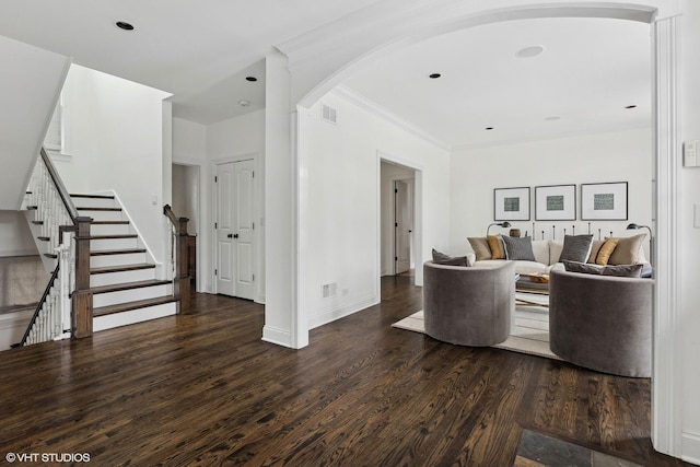 living room featuring crown molding and dark hardwood / wood-style floors