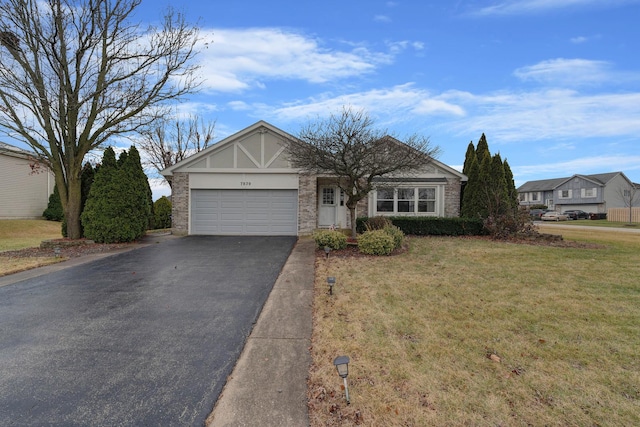 ranch-style house featuring a garage and a front lawn