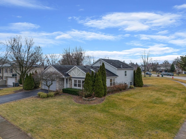 ranch-style house featuring a front yard and a garage