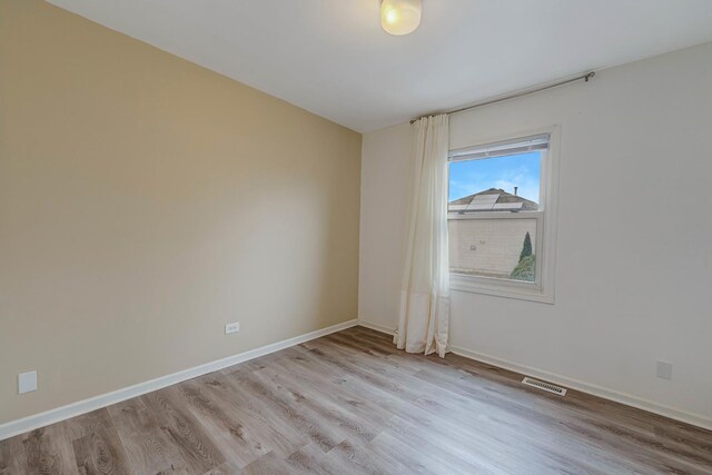 unfurnished room with light hardwood / wood-style floors