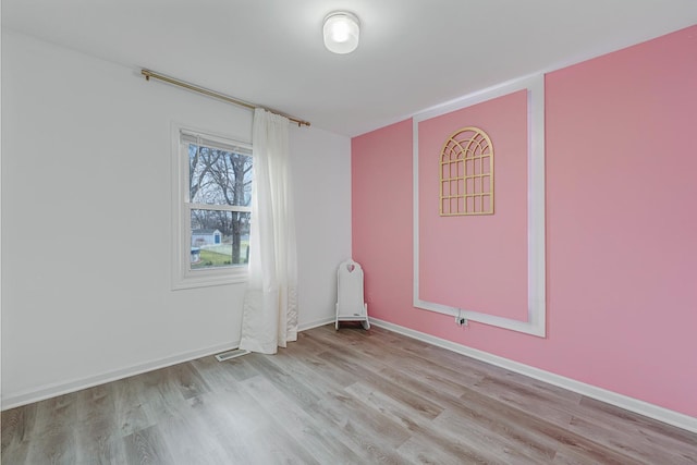 spare room with light hardwood / wood-style flooring