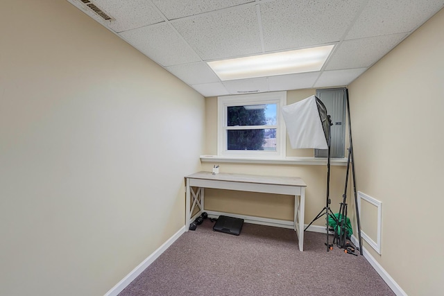 miscellaneous room with a drop ceiling and carpet