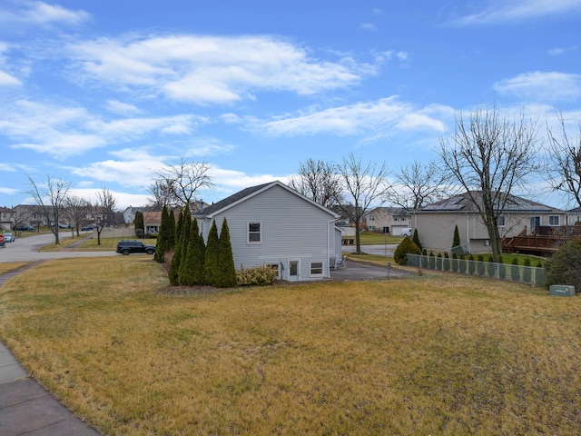 view of side of property with a yard