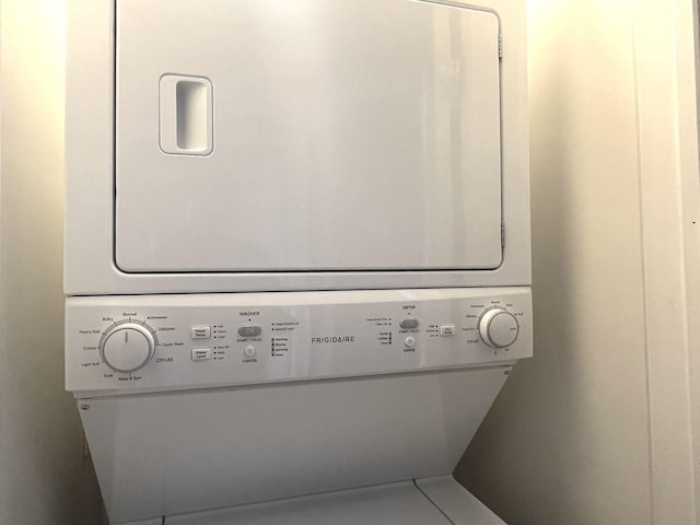 laundry area with stacked washer and dryer and mail boxes