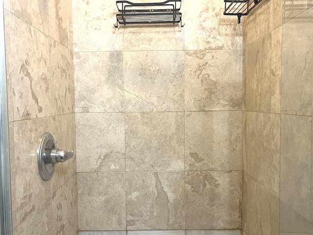 interior details with a tile shower