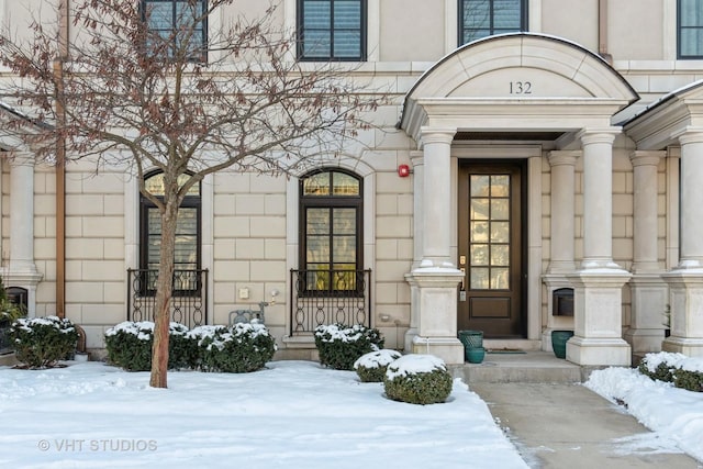 view of snow covered property entrance