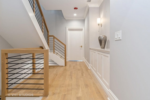 interior space with ornamental molding and light wood-type flooring