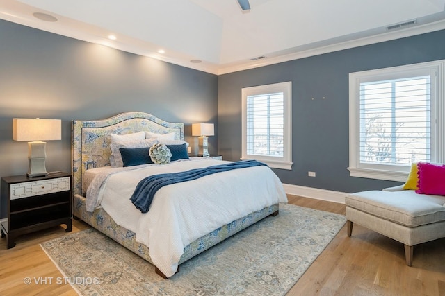 bedroom with crown molding and hardwood / wood-style floors